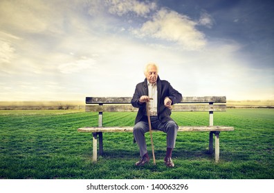 Senior Man Sitting On A Bench Outdoor