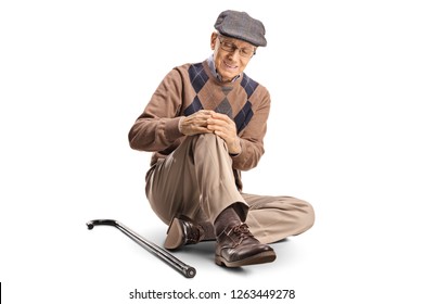 Senior man sitting on the floor and holding his painful knee
