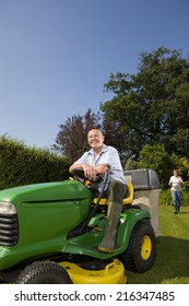 Senior Man Sitting On Riding Lawn Mower