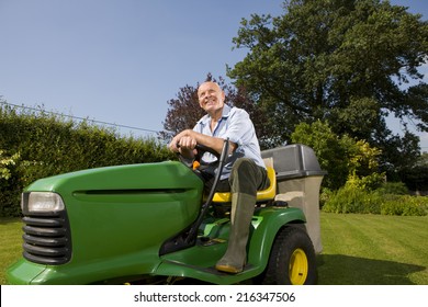 Senior Man Sitting On Riding Lawn Mower