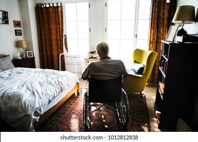 Senior man sitting on the wheelchair alone - Powered by Shutterstock