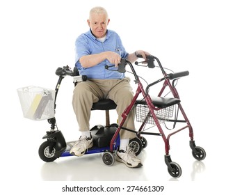 A senior man sitting sideways on his power scooter while holding onto the handles of his wheeling walker.  On a white background.