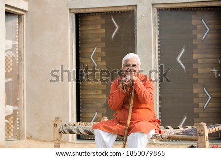 Senior man sitting with walking cane.