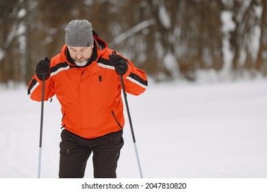 Senior Man Skiing Cross-country In A Forest