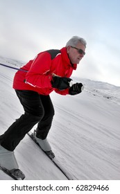 Senior Man Skiing On Snow