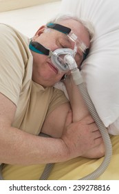 Senior Man With Sleeping Apnea And CPAP Machine