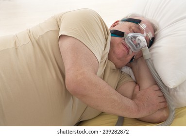 Senior Man with sleeping apnea and CPAP machine
