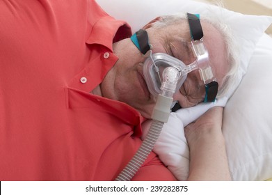 Senior Man With Sleeping Apnea And CPAP Machine