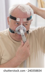 Senior Man With Sleeping Apnea And CPAP Machine