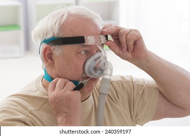 Senior Man With Sleeping Apnea And CPAP Machine