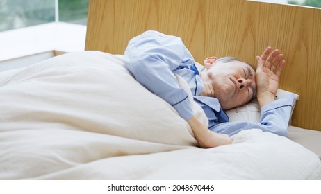 Senior Man Sleeping In Bed