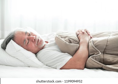 Senior Man Sleeping In Bed. Old Asian Man Sleeping Comfortably In Bed With Curtain Open. Senior Lifesyle Concept.