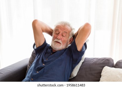 Senior man sleeping on sofa at home. Elderly man relaxing at home - Powered by Shutterstock