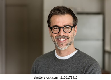 Senior Man Smiling At The Camera. In the kitchen. With glasses - Powered by Shutterstock