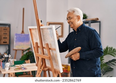 Senior man smiling confident drawing at art studio - Powered by Shutterstock