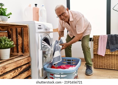 Senior man smiling confident washing clothes at laundry room - Powered by Shutterstock