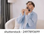 Senior man sneezing into a tissue, experiencing discomfort from cold or allergies, seasonal allergies, virus, flu and sick health, wellness, senior care, and medical treatment for respiratory