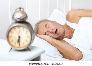 Senior Man Is Snoring In Bed. Health Care Concept