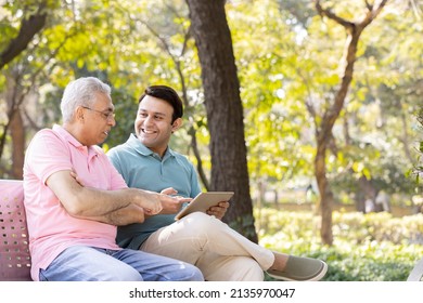 Senior man with son watching social media content on digital tablet at park
 - Powered by Shutterstock