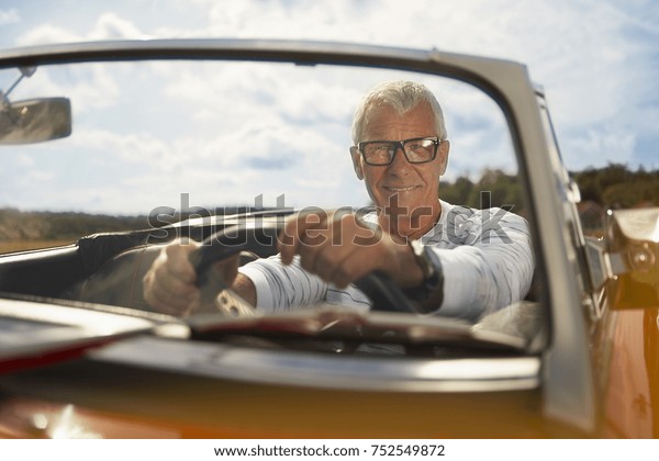 Senior man in sports\
car