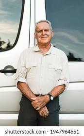 Senior Man Standing By The Camper Van