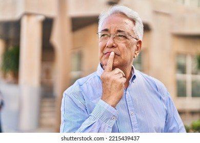 Senior man standing with doubt expression at street - Shutterstock ID 2215439437
