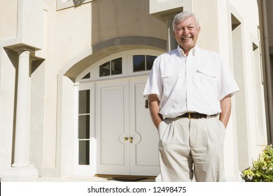 Senior Man Standing Outside Front Door Of House