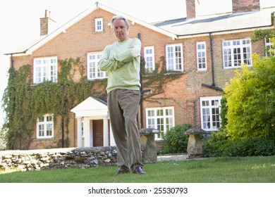 Senior Man Standing Outside House