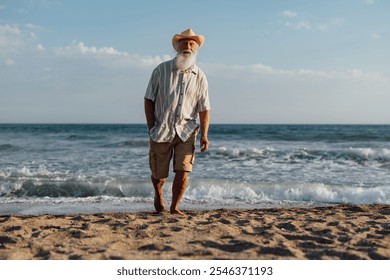 A senior man standing thoughtfully on the beach, gazing at the v - Powered by Shutterstock