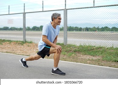 Senior Man Stretching Legs Muscle Before Running Or Jogging, Old Man Warming Up Exercise To Prevent Injury. Concept Healthcare In Elderly People                            