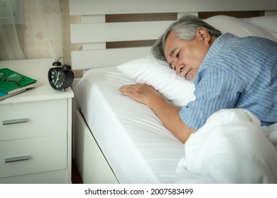 Senior man Suffering in bed cannot sleep from insomnia , Senior male , old man don't want to wake up from the bed in the morning - senior insomnia problem concept