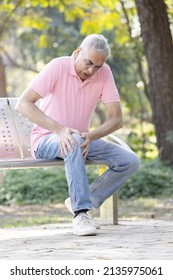 Senior man suffering from knee pain at park
