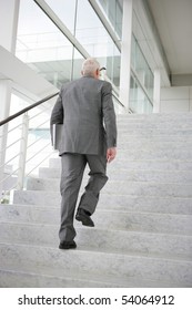 Senior Man In Suit Climbing Stairs