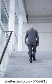 Senior Man In Suit Climbing Stairs