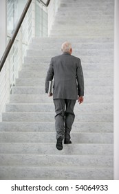 Senior Man In Suit Climbing Stairs