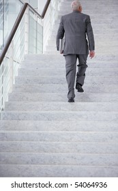 Senior Man In Suit Climbing Stairs