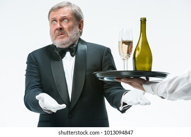 The Senior Man In Suit Complaining For The Bad Wine Isolated On White Studio Background. Concept Of Bad Service