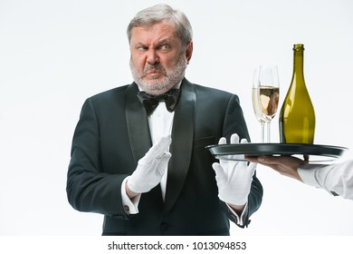 The Senior Man In Suit Complaining For The Bad Wine Isolated On White Studio Background. Concept Of Bad Service