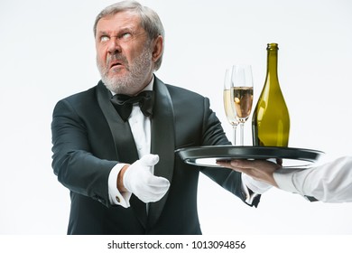 The Senior Man In Suit Complaining For The Bad Wine Isolated On White Studio Background. Concept Of Bad Service