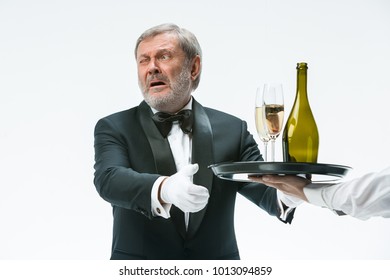 The Senior Man In Suit Complaining For The Bad Wine Isolated On White Studio Background. Concept Of Bad Service