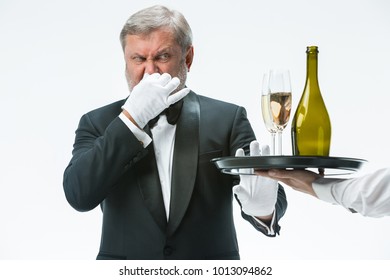 The Senior Man In Suit Complaining For The Bad Wine Isolated On White Studio Background. Concept Of Bad Service