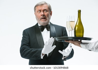 The Senior Man In Suit Complaining For The Bad Wine Isolated On White Studio Background. Concept Of Bad Service