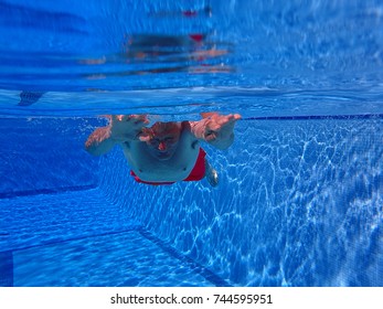 Senior Man Swimming Under Water