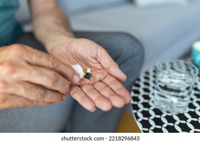 Senior Man Takes Pill With Glass Of Water In Hand. Stressed Mature Man Drinking Sedated Antidepressant Meds. Man Feels Depressed, Taking Drugs. Medicines At Work