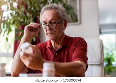 Senior Man Taking Prescription Medicine At Home
