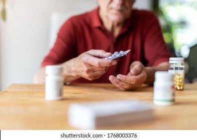 Senior Man Taking Prescription Medicine At Home
