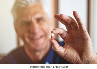 Senior Man Taking Tablet Isolated On White