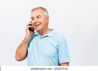 Senior Man Is Talking To Someone On The Phone.Senior Man On The Phone