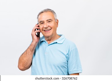 Senior Man Is Talking To Someone On The Phone.Senior Man On The Phone