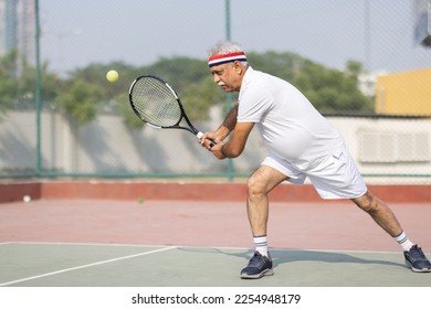 Senior man tennis player on tennis court. - Powered by Shutterstock